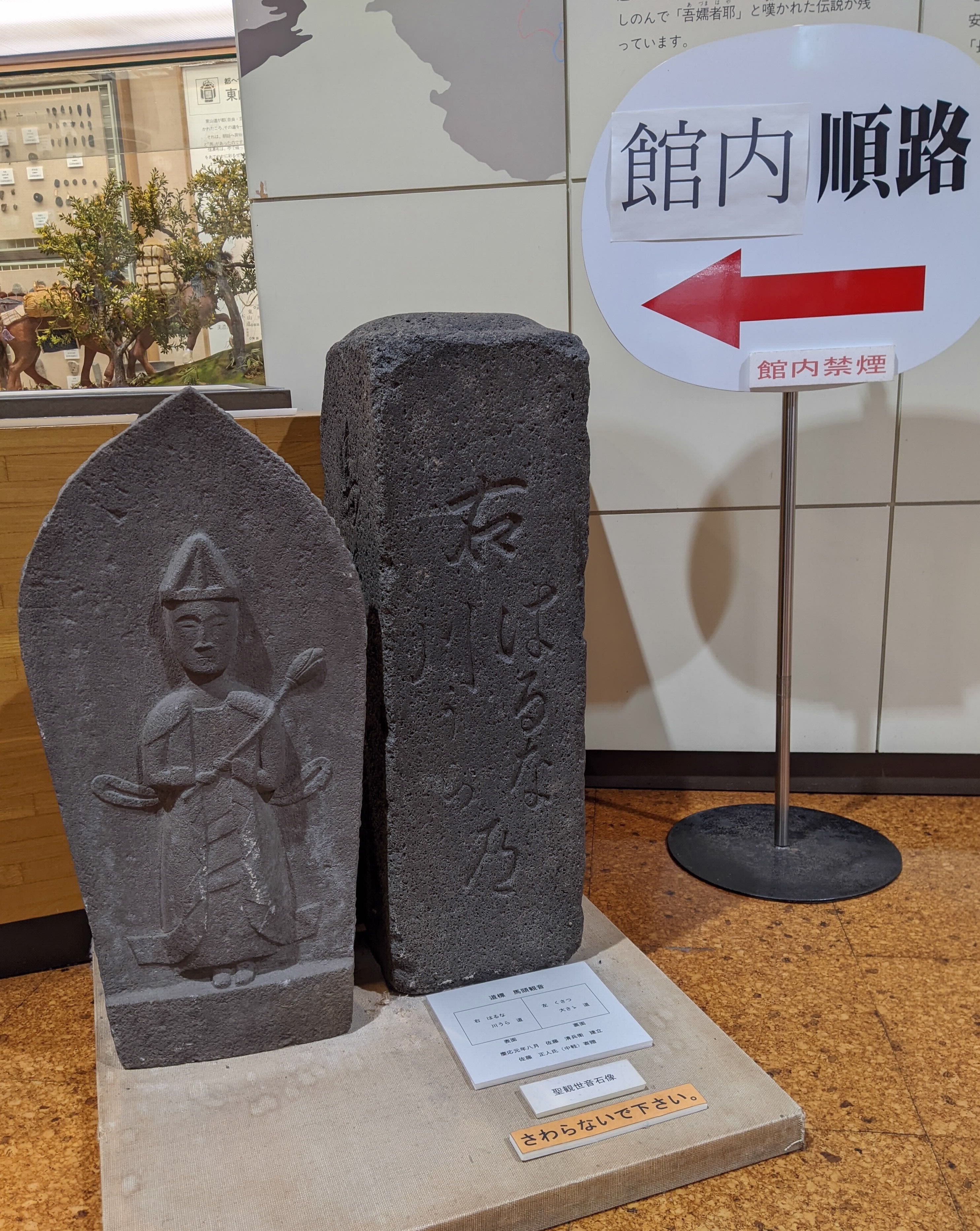 展示室内の道標と馬頭観音（石碑）の画像